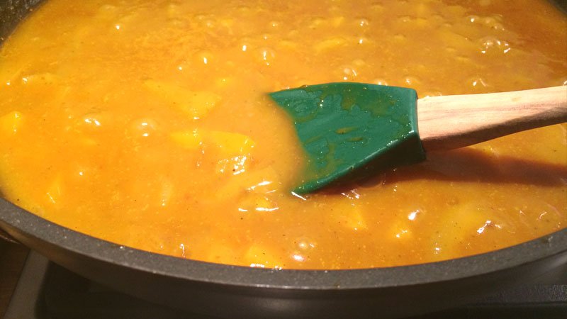 Detalle de la salsa de curry con melocotón y cebolla